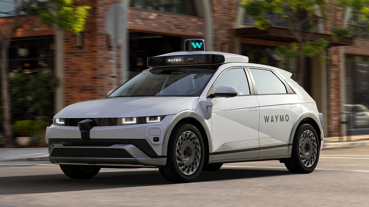 Hyundai Ioniq 5 EV converted into Waymo robotaxi, driving on suburban street in USA.