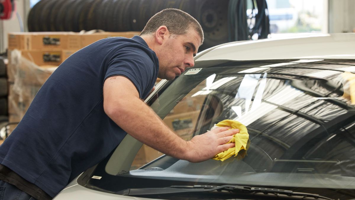 mechanic buffing windscreen
