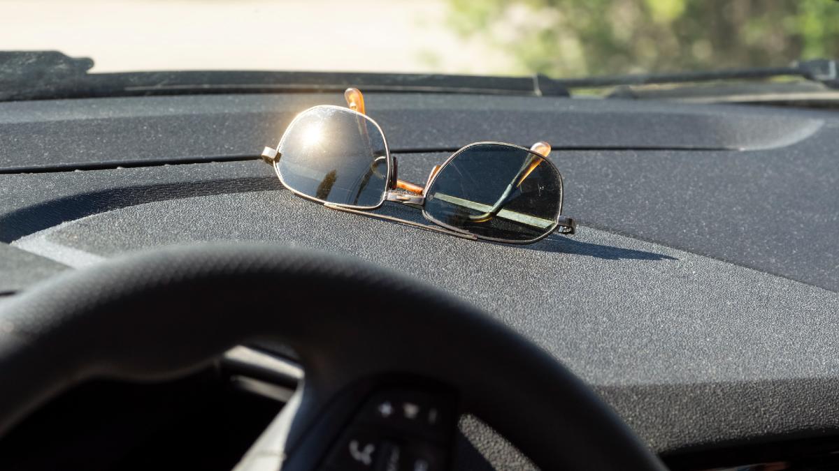 Sunglasses sitting on dashboard.