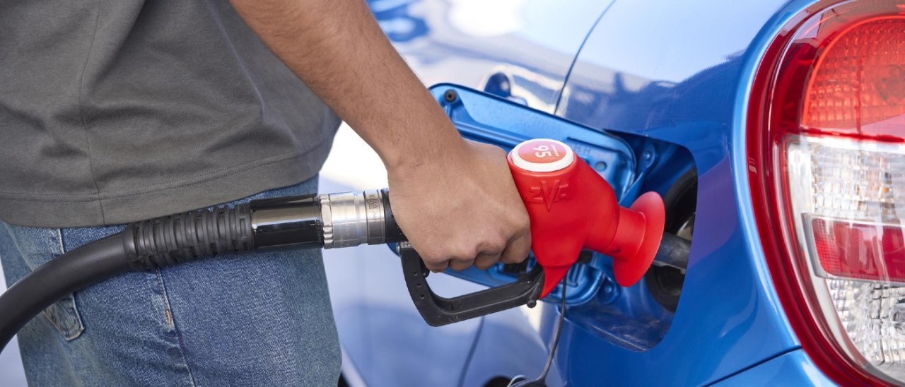 A person filling up their car with petrol