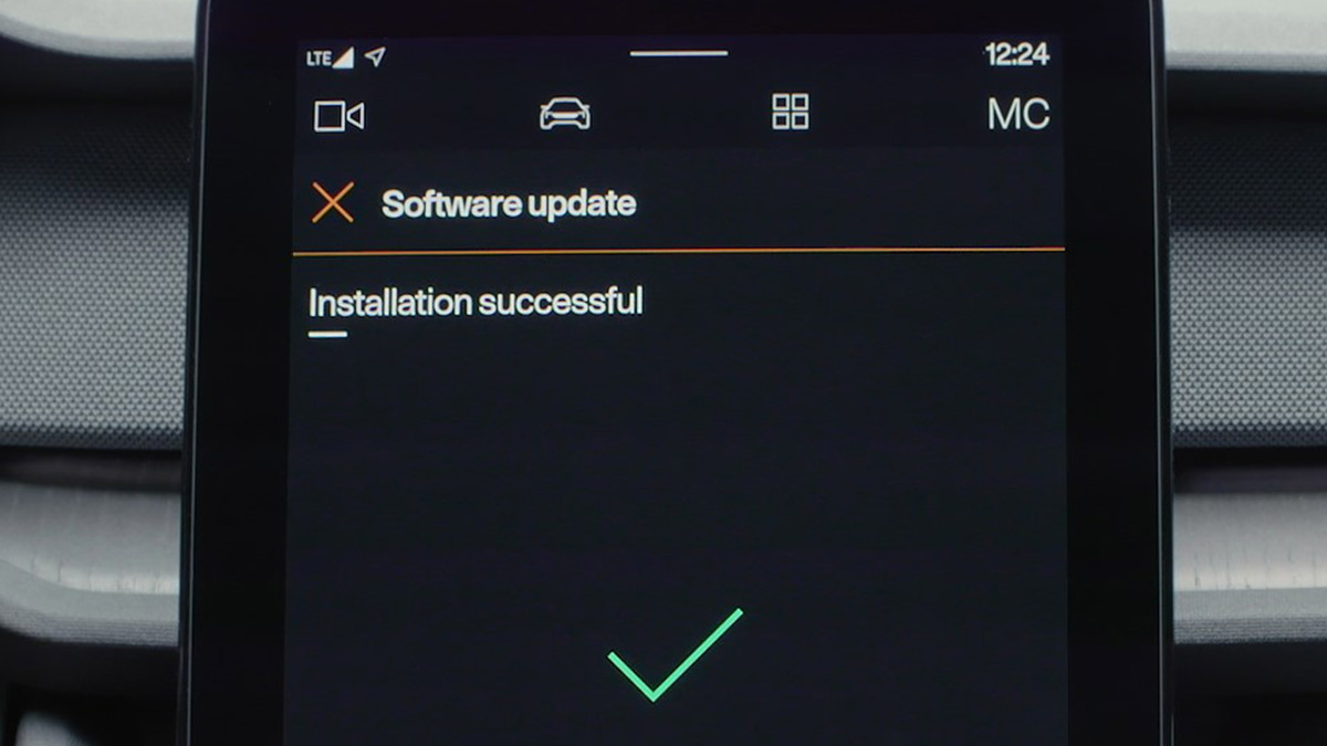 Infotainment screen of Polestar 2 electric car with green tick confirming successful installation of over-the-air software update.