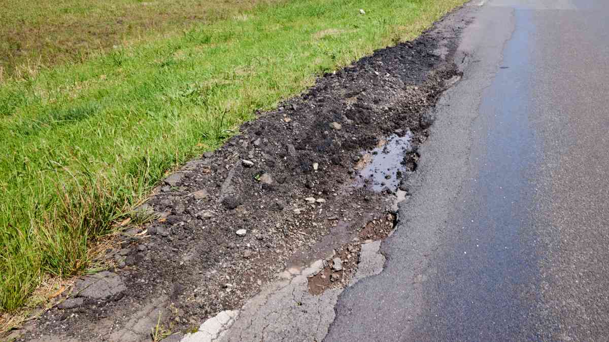 gravelley pothole on side of road