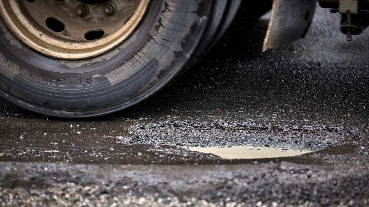 car tyre near pothole in road