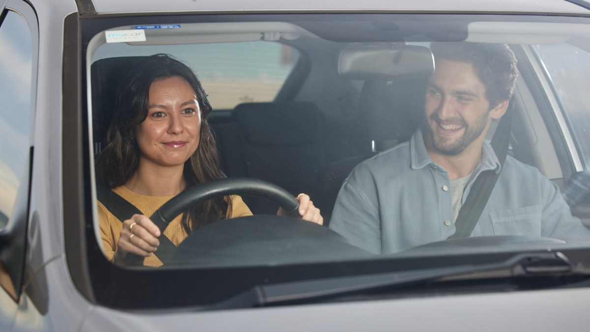 woman driving car with man in passenger seat