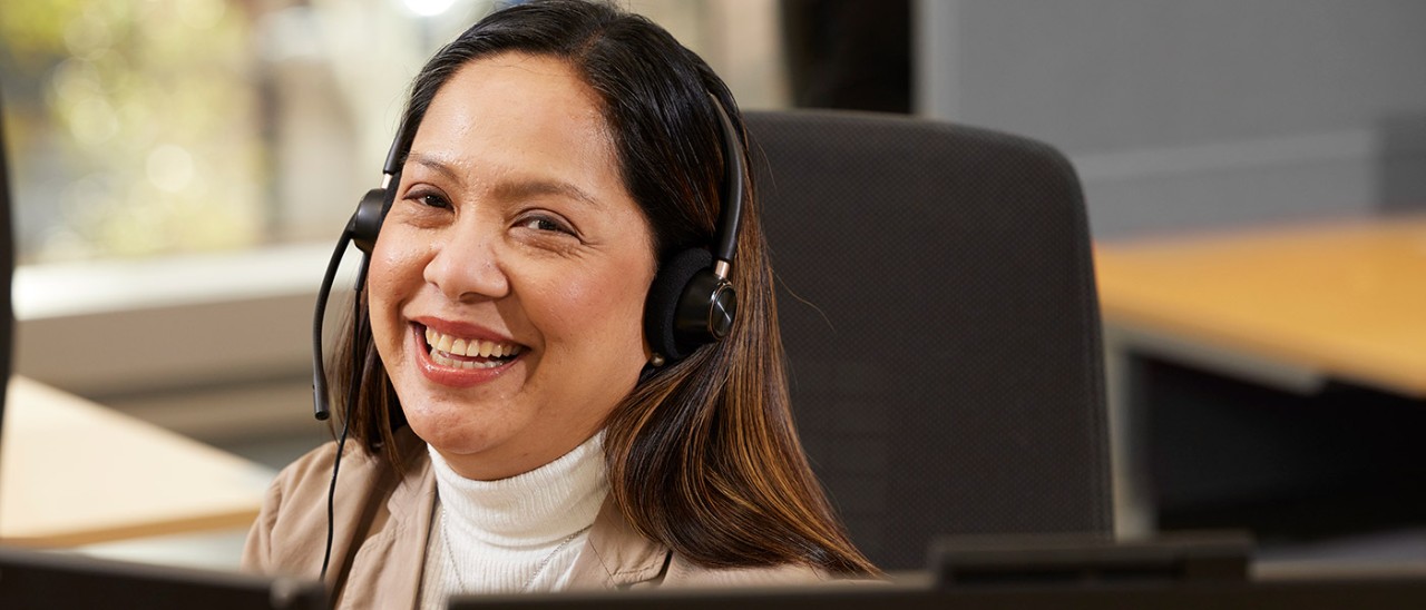 RACV consultant on phone smiling 