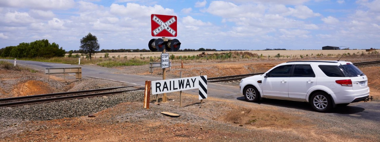 A white station wagon crossing a level crossing in regional Victoria