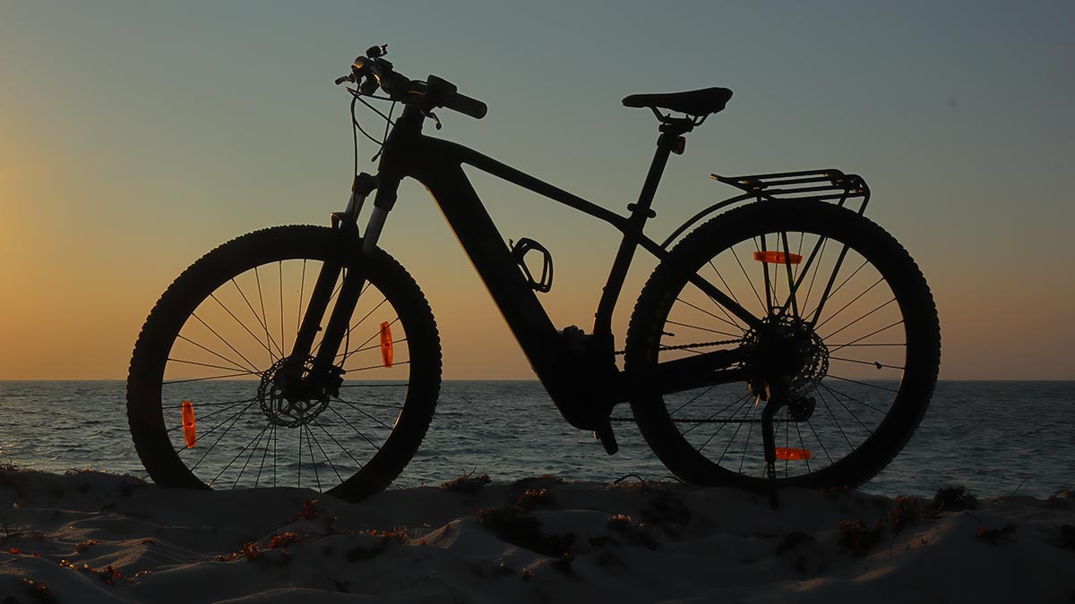 Electric bike silhouette on beach