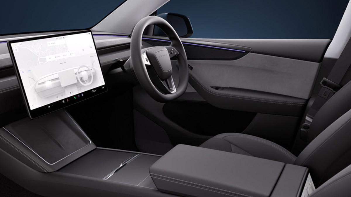 Cockpit of 2025 Tesla Model Y showing big screen and steering wheel