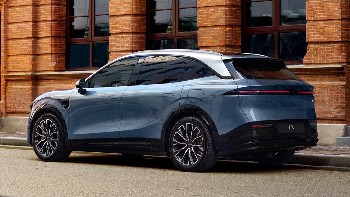 Rear view of blue Zeekr 7X SUV on street in front of brick building