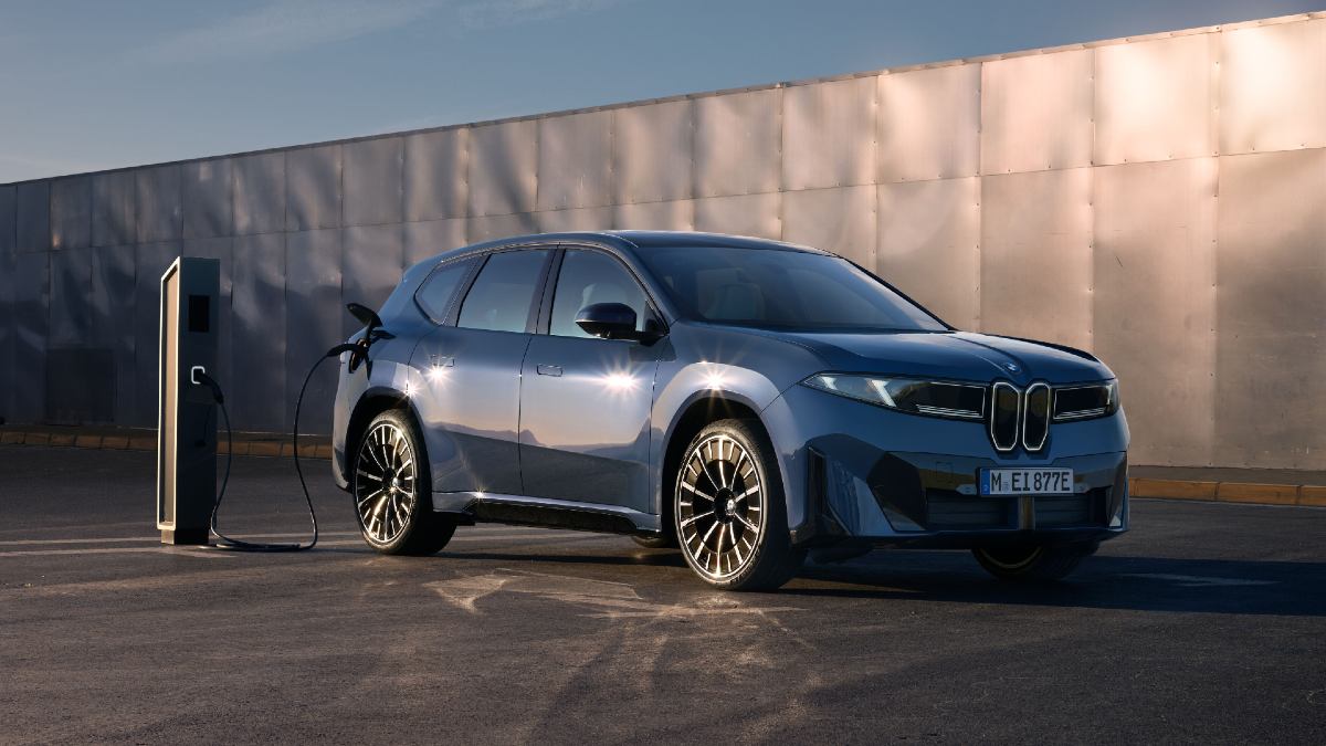 blue 2026 BMW iX3 charging at public charger