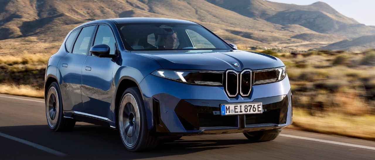blue 2026 BMW iX3 driving on road