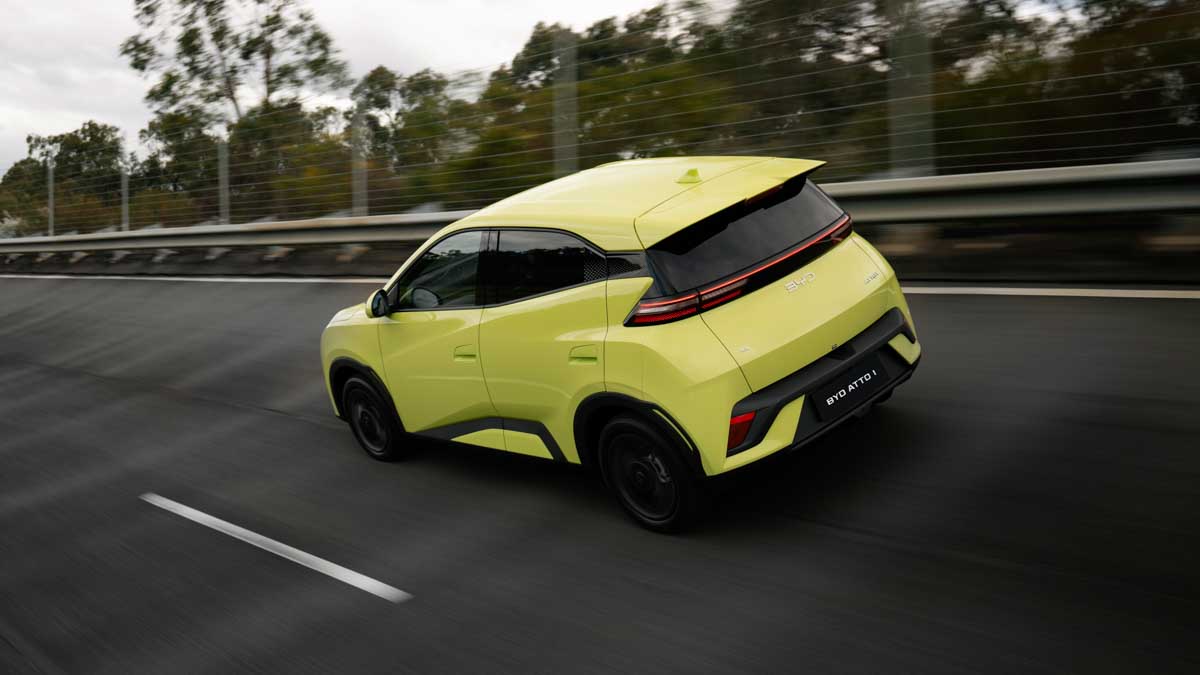 lime green 2026 BYD Atto 1 driving on road as seen from rear