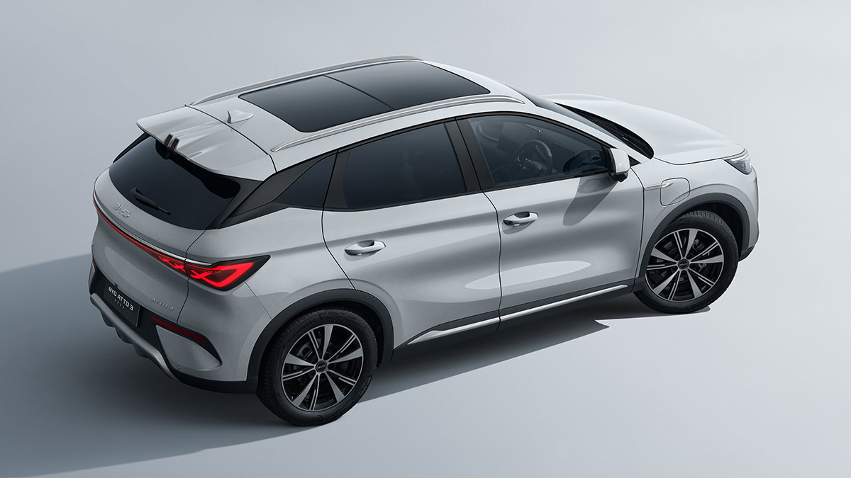 Side overhead view of white BYD Atto 3 Dynamic electric SUV with revised exterior design body sculpting and large glass sunroof.