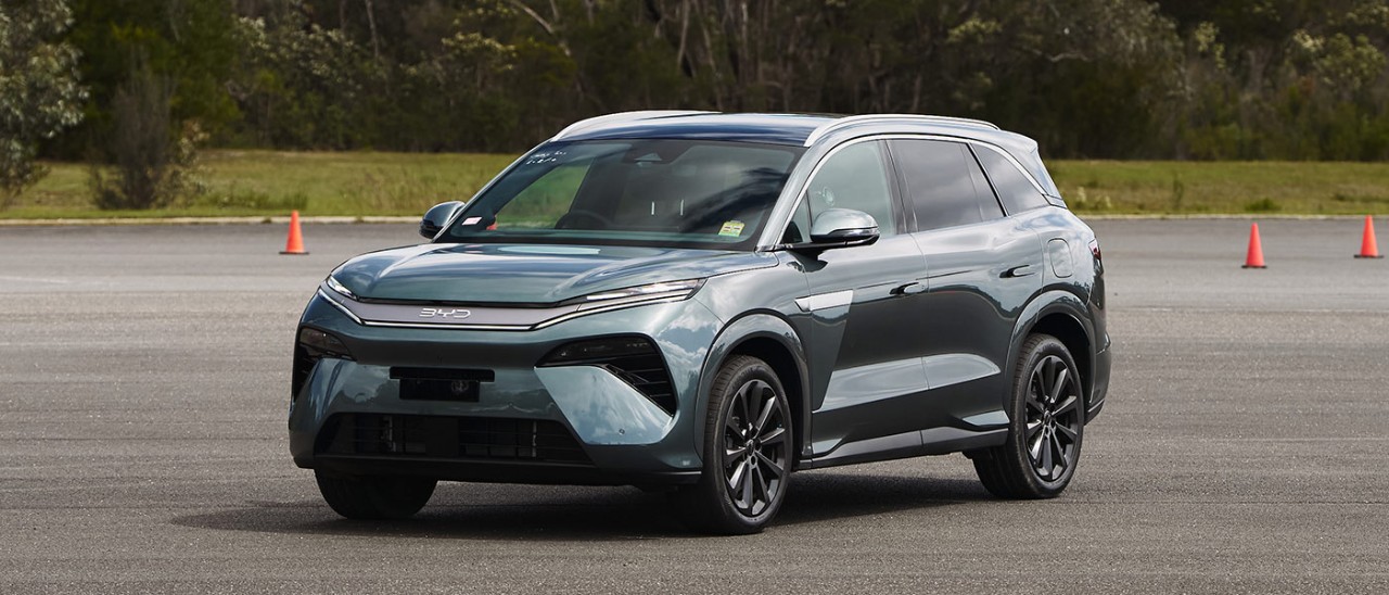 BYD Sealion 8 large SUV in dark aquamarine metallic colour parked on forecourt at bushy Lang Lang proving ground in regional Victoria.
