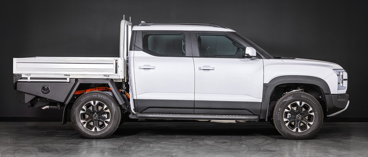 Studio shot of white BYD Shark 6 Cab-Chassis dual-cab ute fitted with optional alloy tray.