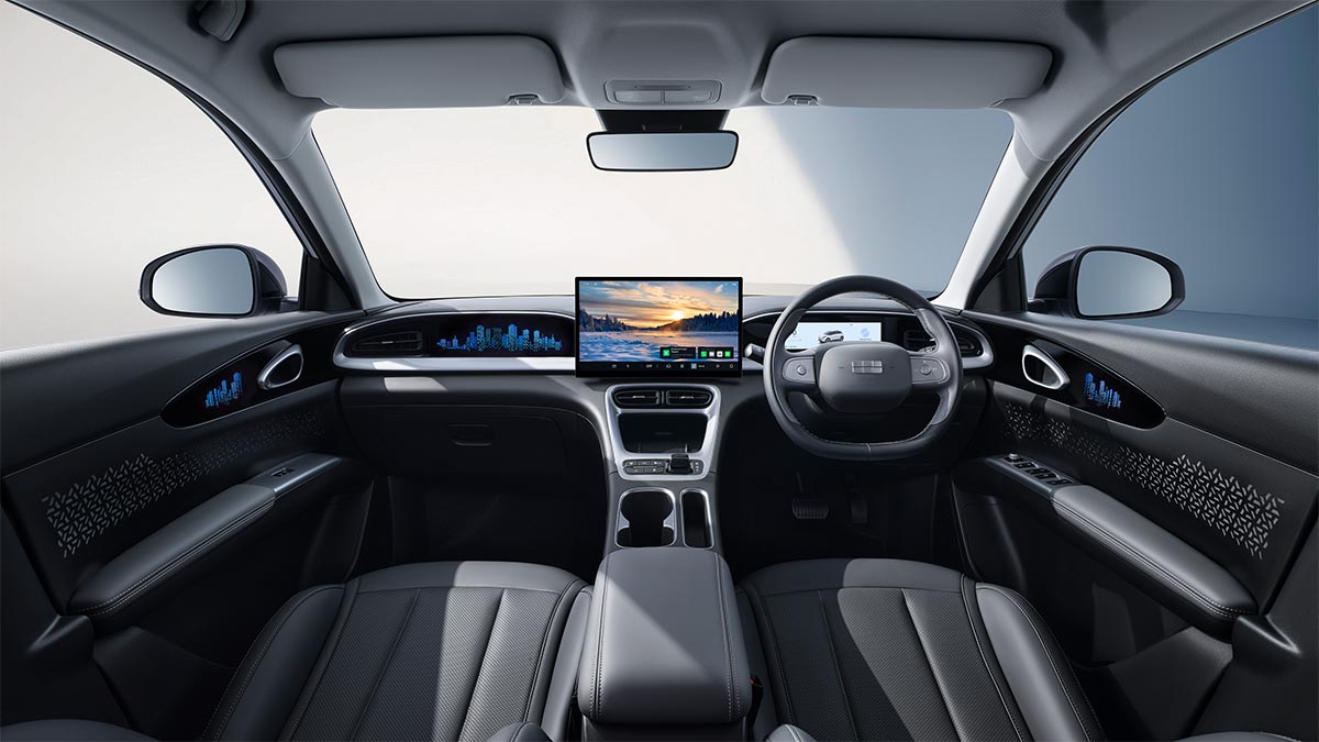 Grey cockpit of Geely EX2 city car with large central screen, digital instruments and backlit city graphics on dash and doors.
