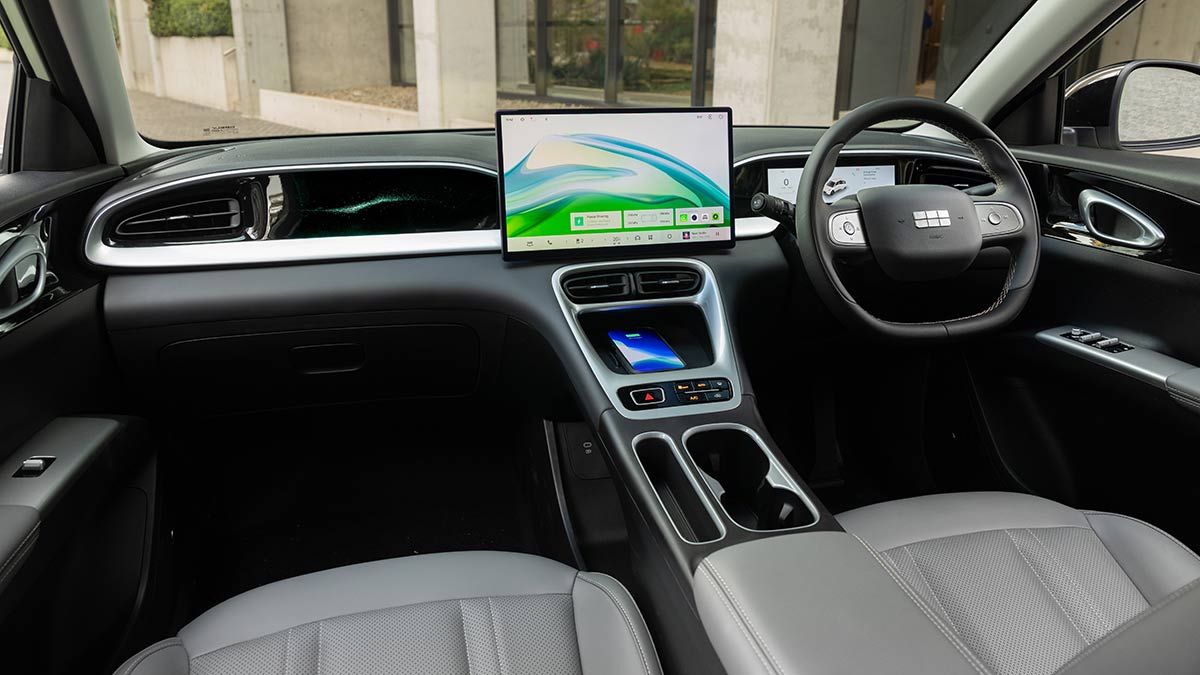 Geely EX2 Inspire EV’s front compartment with dual screens and dark grey trim with metallic highlights.