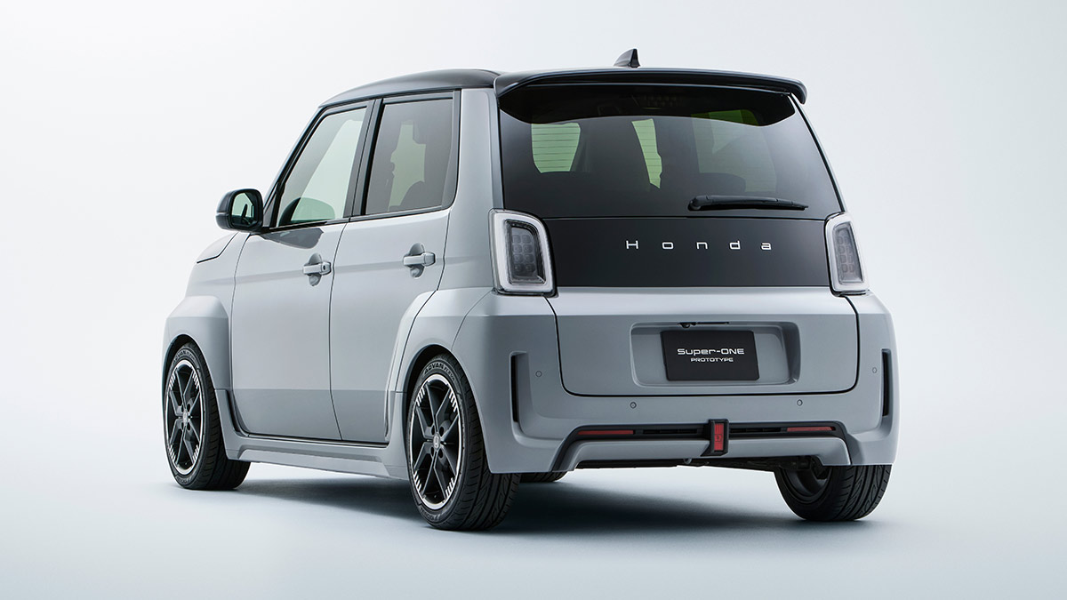 Studio shot showing rear end of Honda Super-One EV hatch with light grey body paint, black tailgate insert,16-inch black alloy wheels.