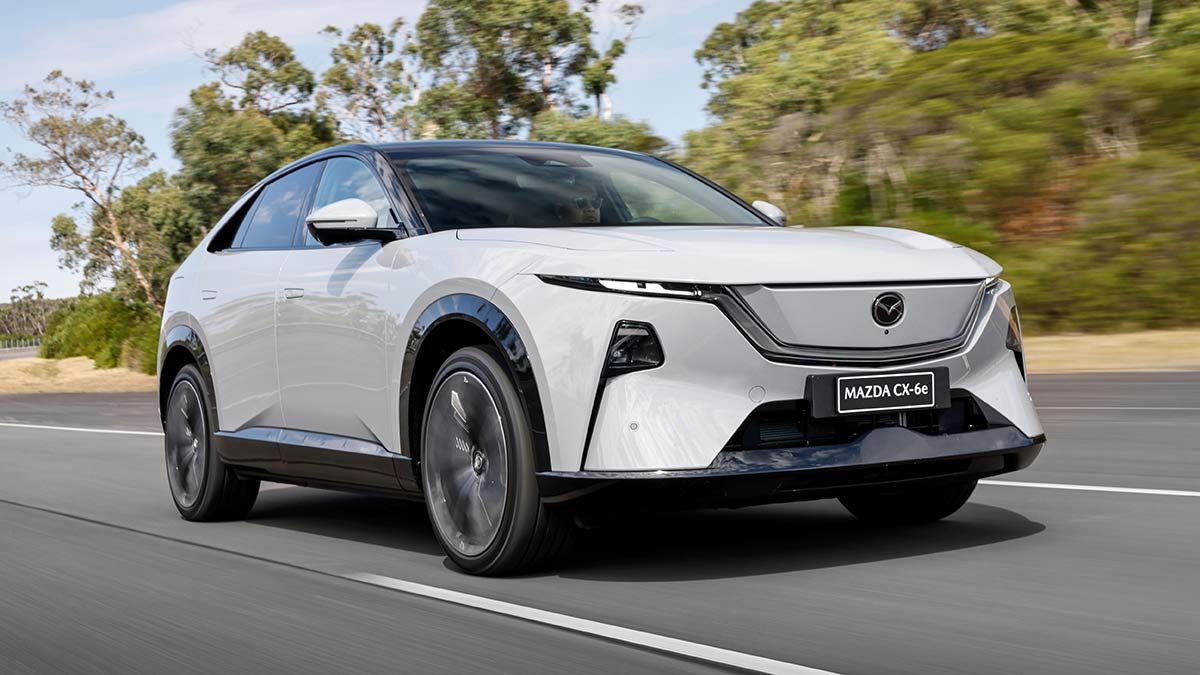 White LHD Euro-spec Mazda CX-6e SUV driving on ride and handling circuit at Lang Lang proving ground in Victoria.