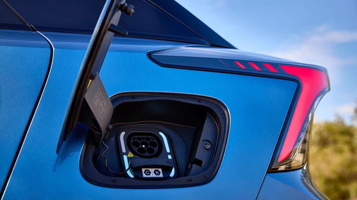 Charging flap open at left rear panel of blue MG4 EV hatch.