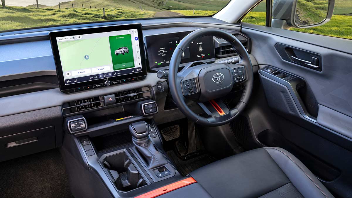 Cockpit of Toyota RAV4 Edge SUV showing 12.9-inch centre touchscreen and 12.3-inch digital instrument cluster.