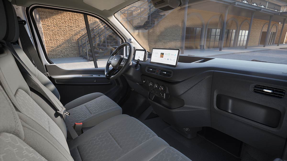 Dashboard of left-hand-drive Ford Transit City electric van with dual digital screens and multi-function steering wheel.