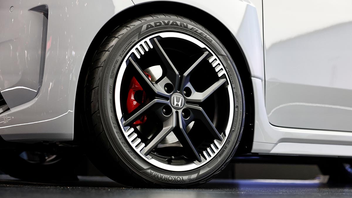 Front left 16-inch black alloy wheel on Honda Super-One EV with red brake calliper and low-profile tyre. 