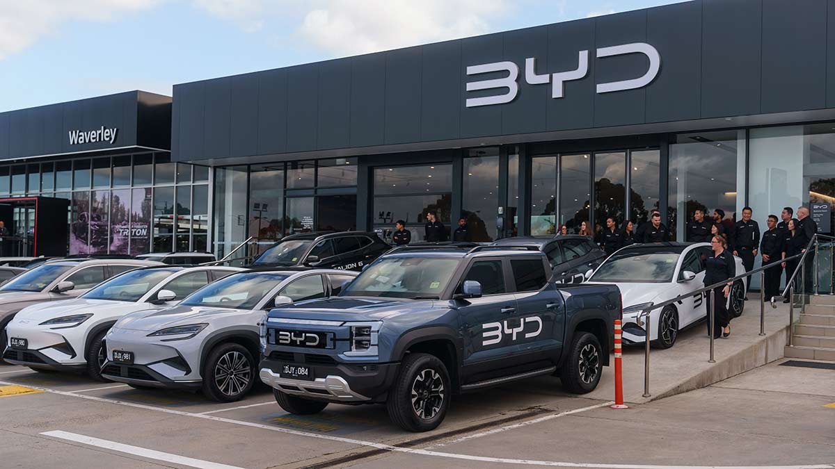 BYD dealership in Waverley, Victoria, with staff out front among BYD cars including Shark 6 ute.