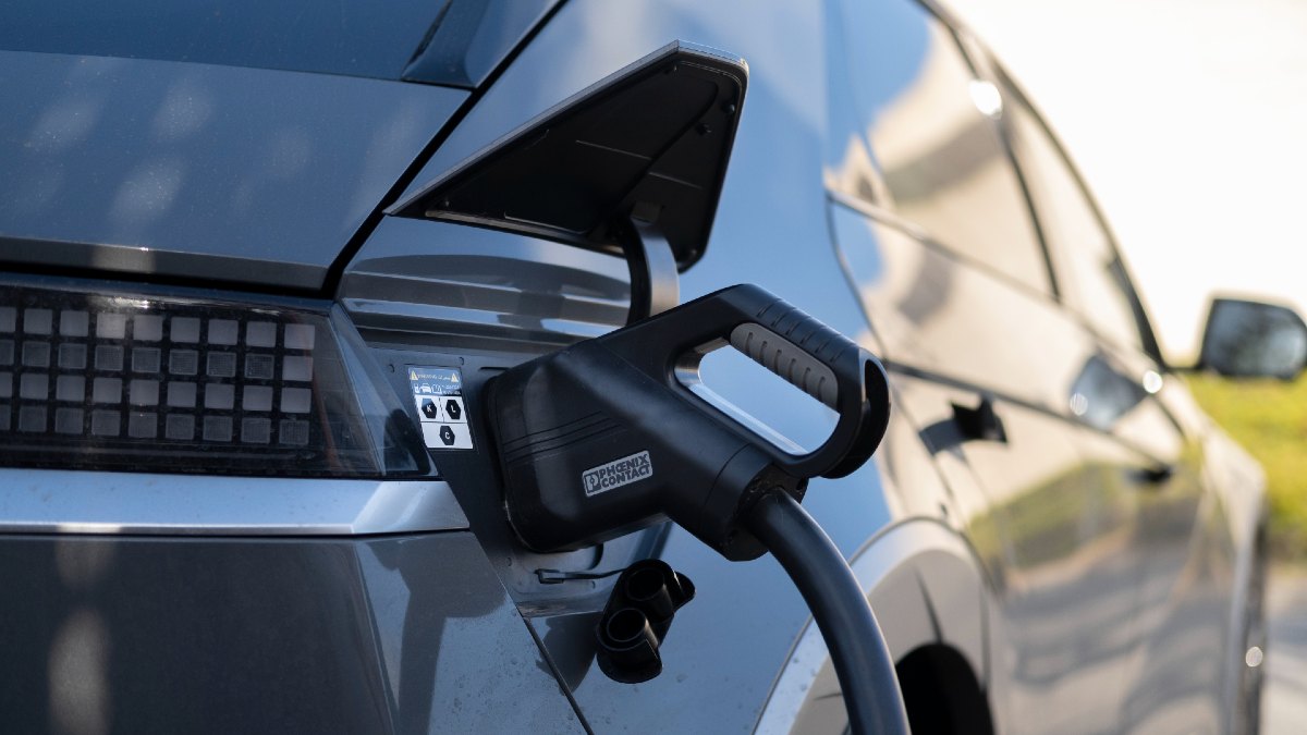 EV charger plugged into black EV