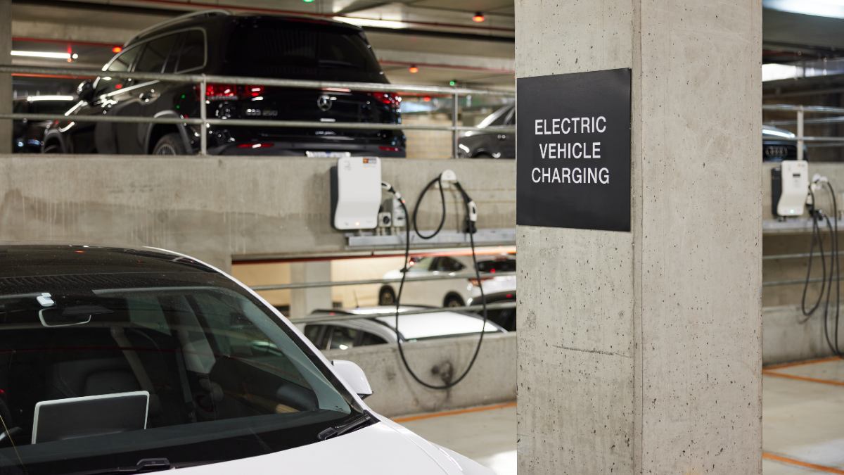 person charging their EV at a destination charging station