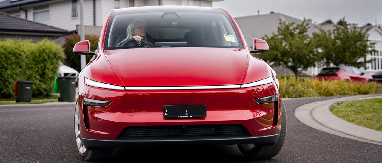 Woman driving Tesla Model Y around Melbourne streets
