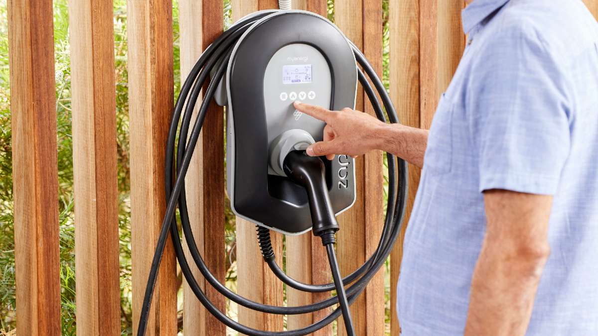man turning on EV charger