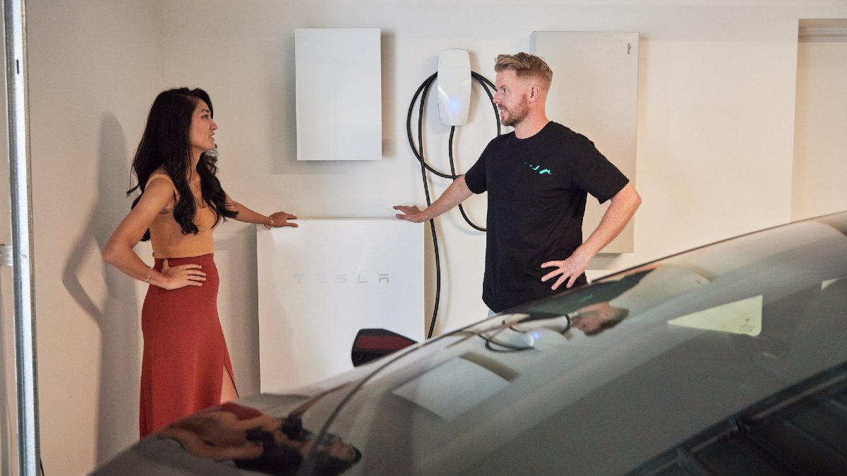 woman and man talking in front of a home EV charger