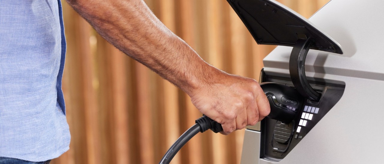 man charging a white EV