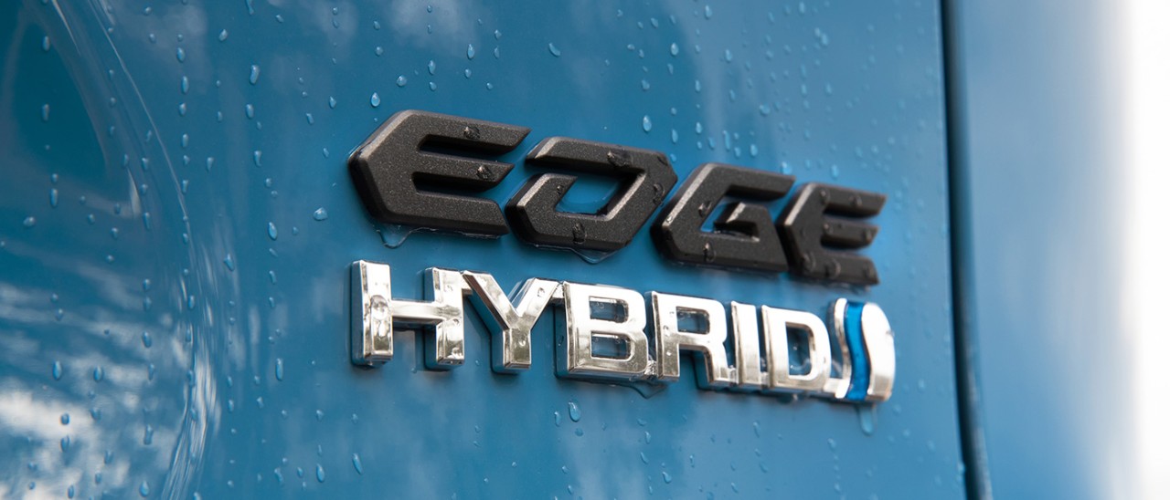 Blue Toyota RAV4 Edge medium SUV with raindrops on tailgate and hybrid badge