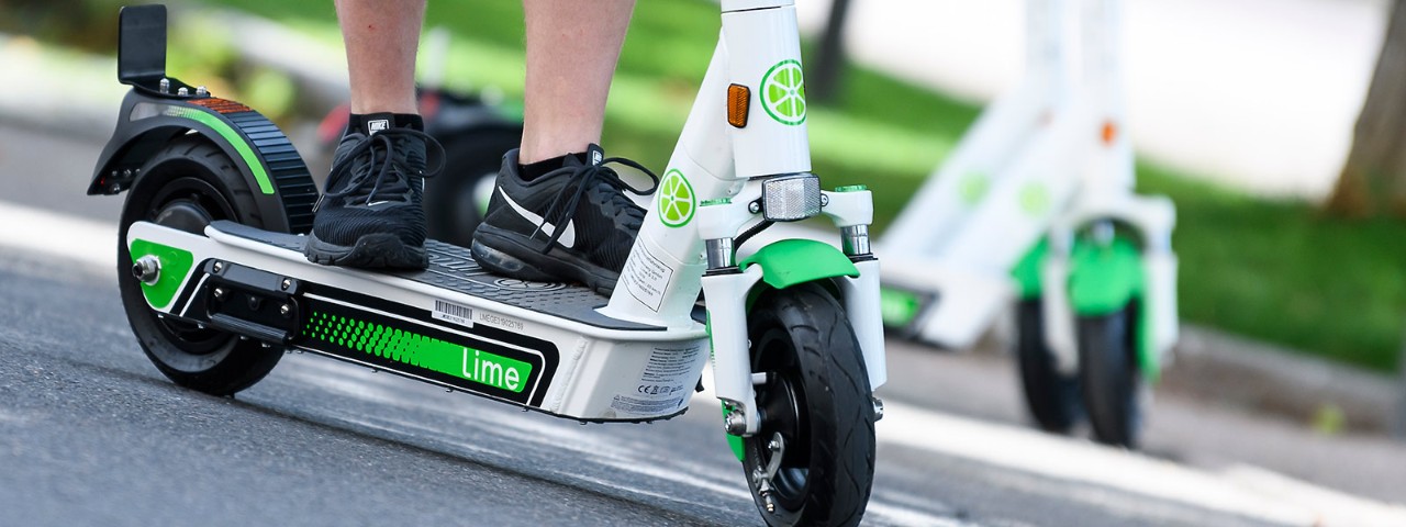 1161842025 Person riding an electric scooter