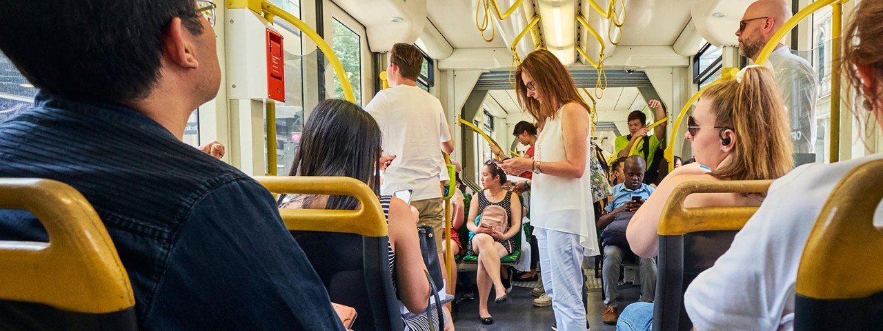 A woman uses a mobile phone on a tram in Melbourne