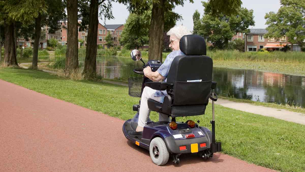 Elderly woman in mobility scooter