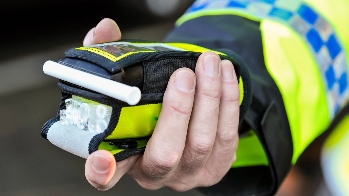 police officer holding breathalyser