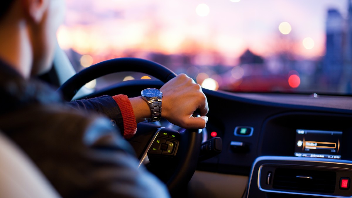 interior of car with person driving at sunset