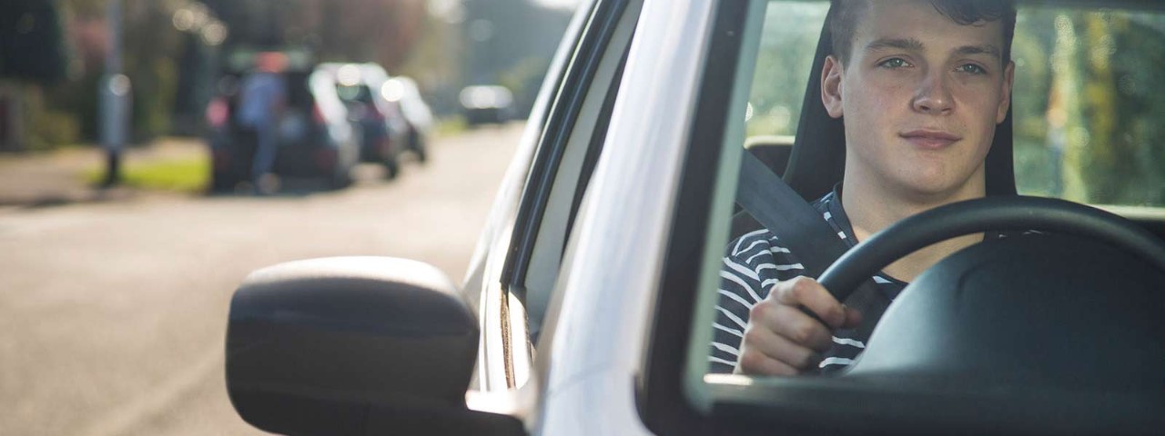 Close up of male driving car