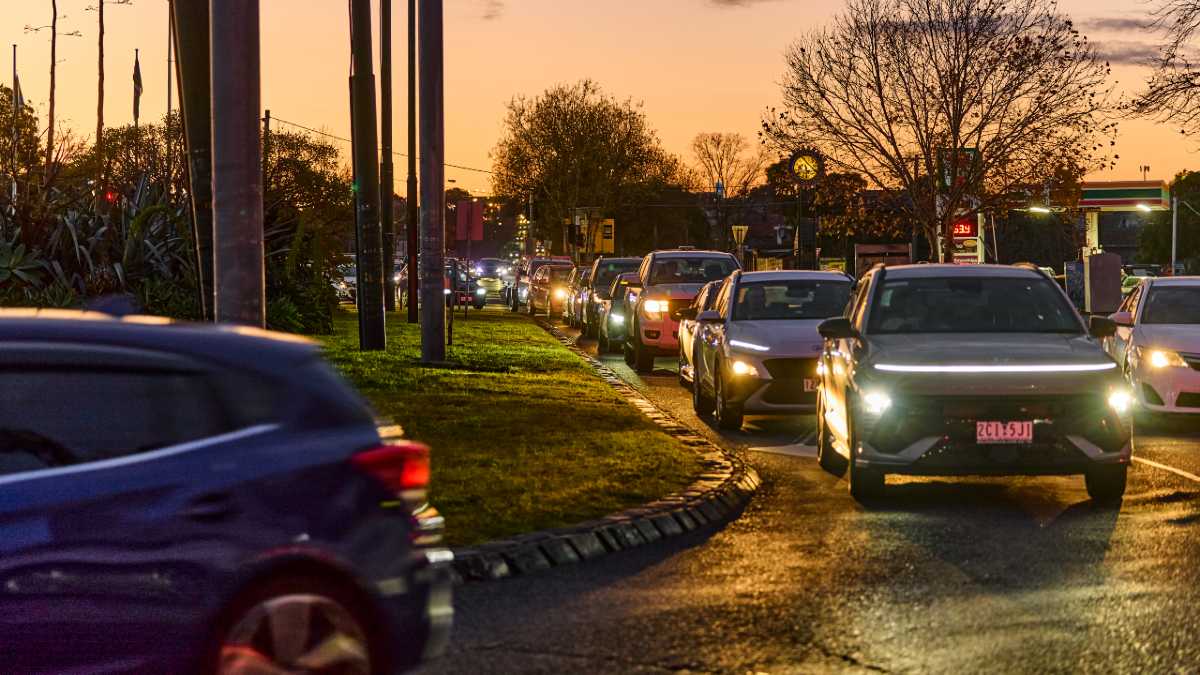 Heavy traffic with headlights on at sunset at the intersection of Mt Alexander and Keilor roads in Essendon