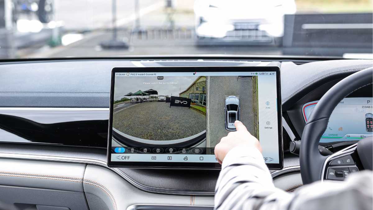person using touchscreen in car