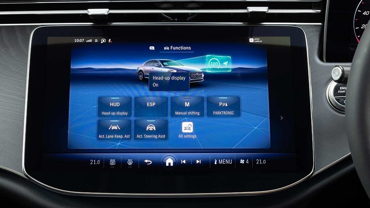 Central dash screen of Mercedes-Benz E200 showing head-up display settings, ESP and driver assistance for parking, lane keeping and steering