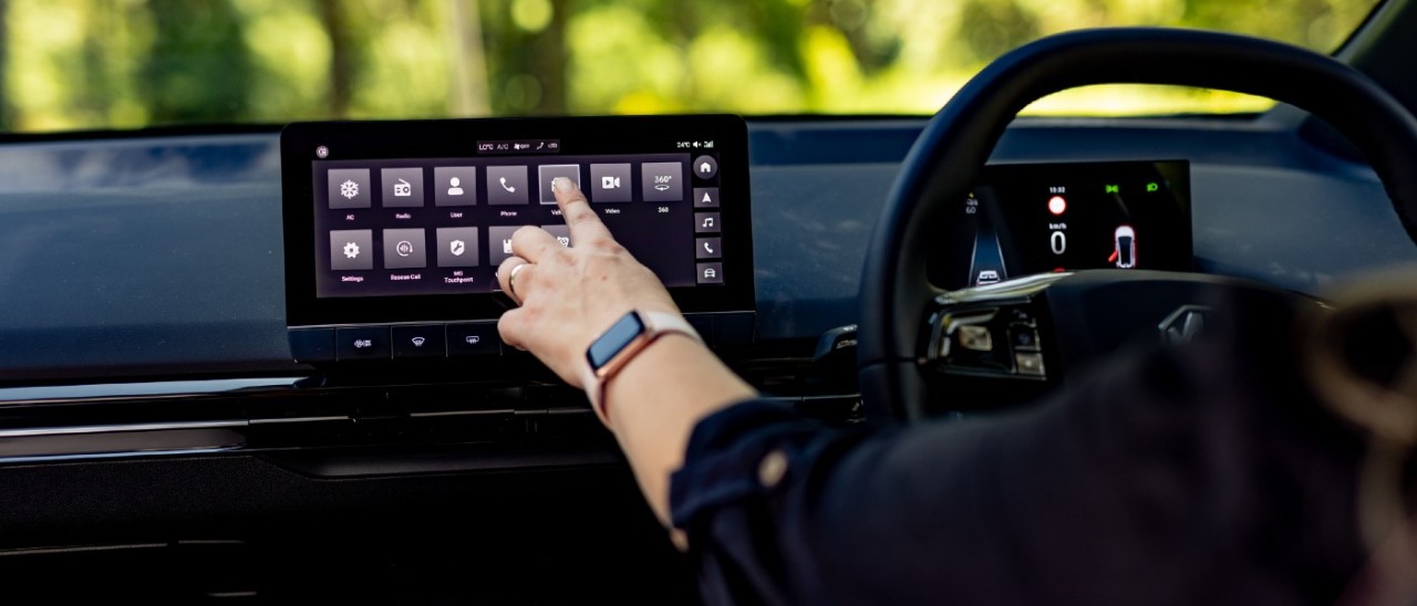 woman touching car infotainment screen