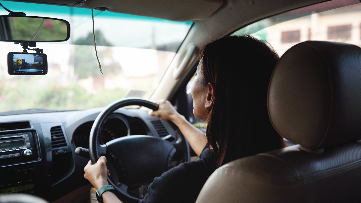 woman driving with dashcam visible