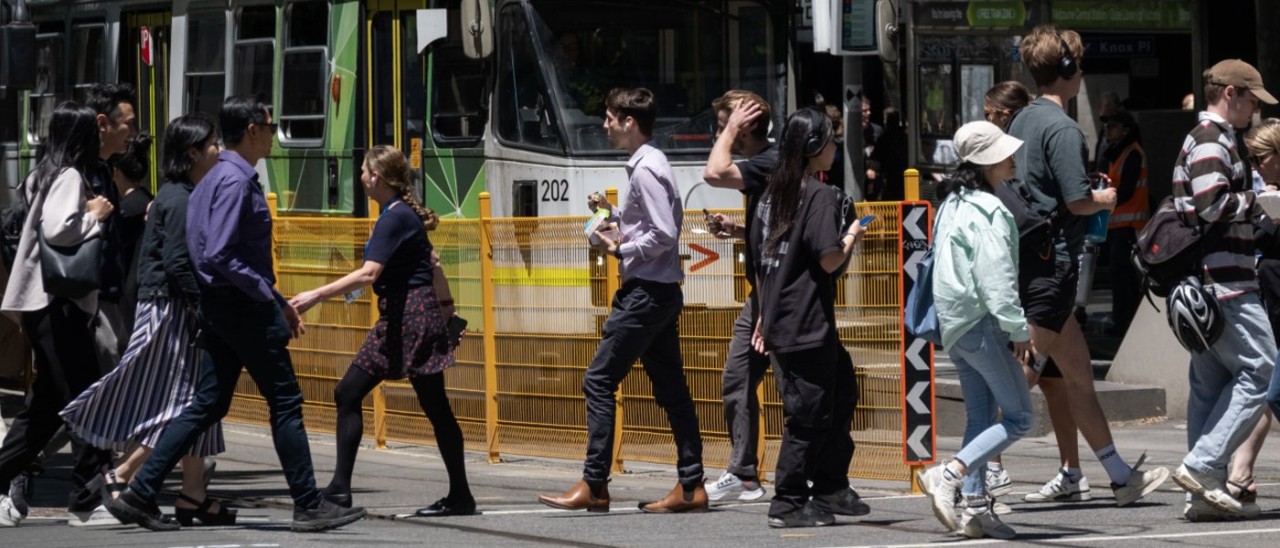 Pedestrians Melbourne Pedestrians crossing in front of a tram near Melbourne Central Station