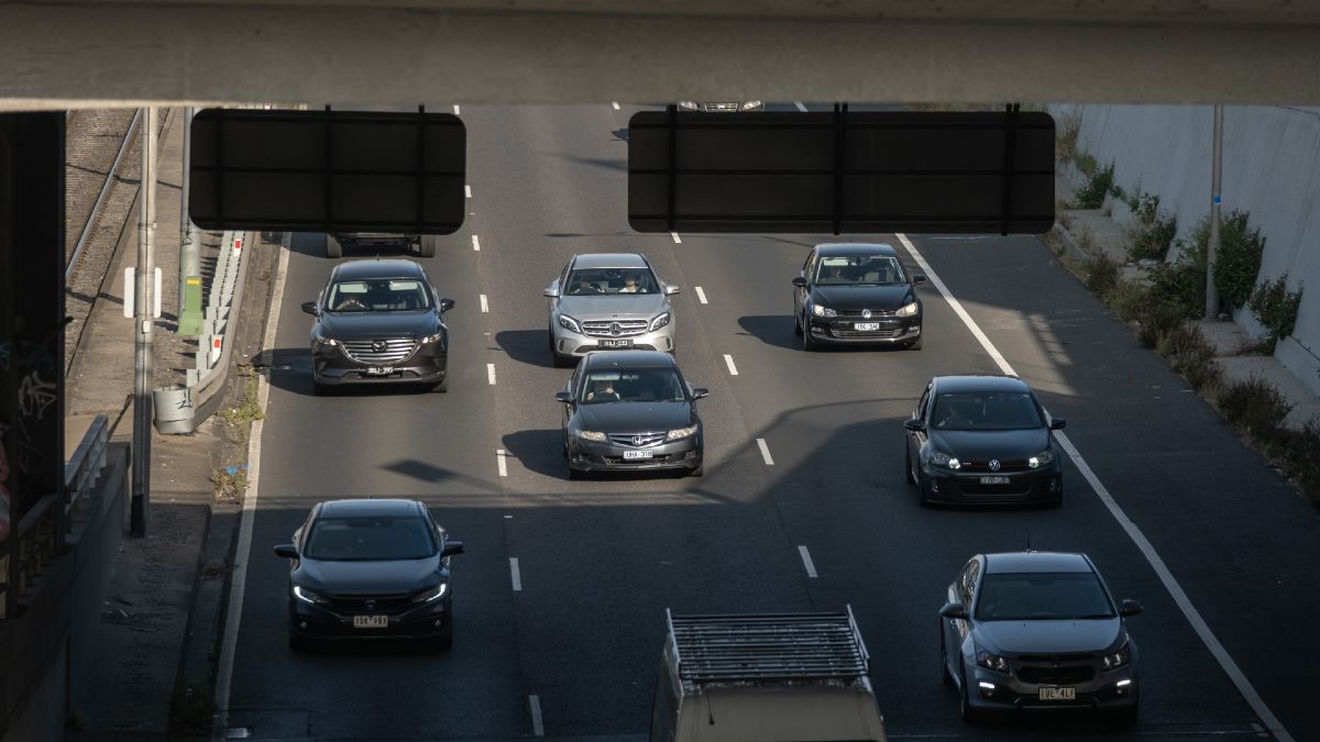 multiple cars driving down a three-lane highway in Melbourne