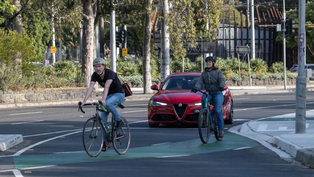 Two bike riders using a bike lane in inner city Melbourne