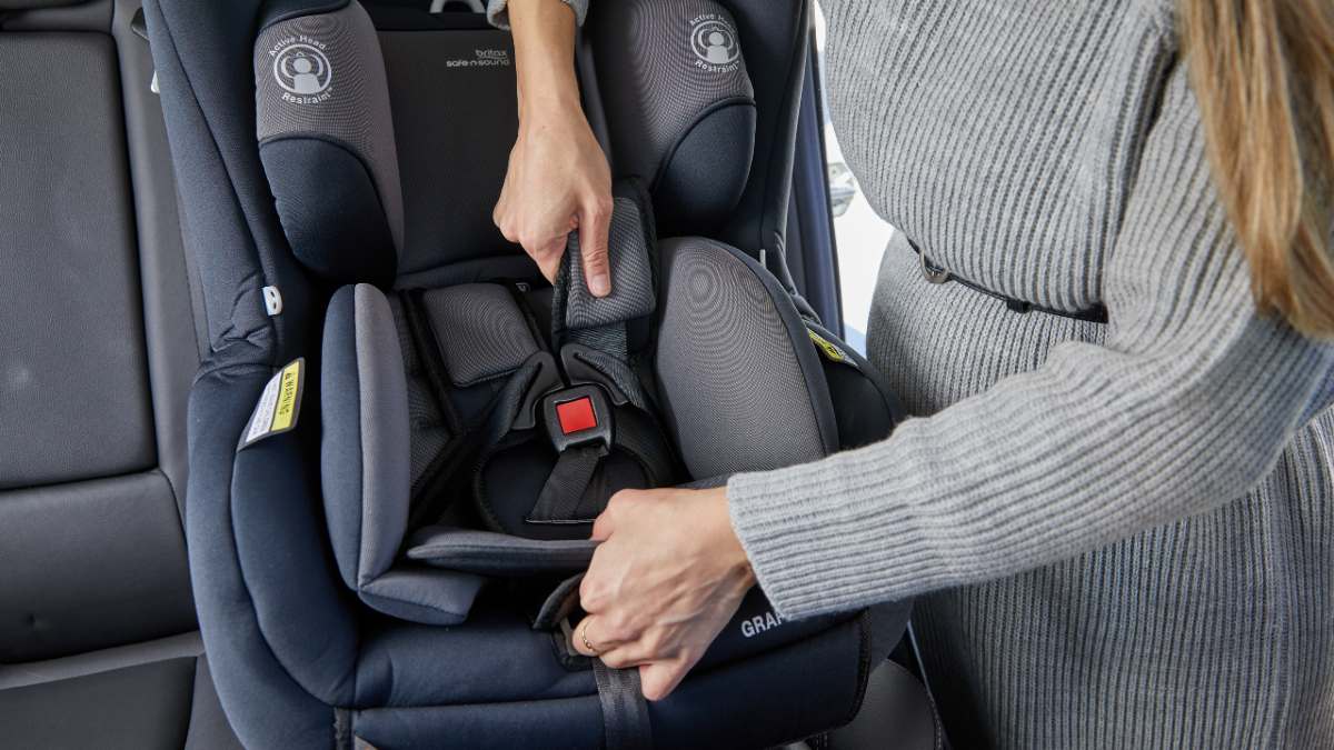 Man fixing booster seat.